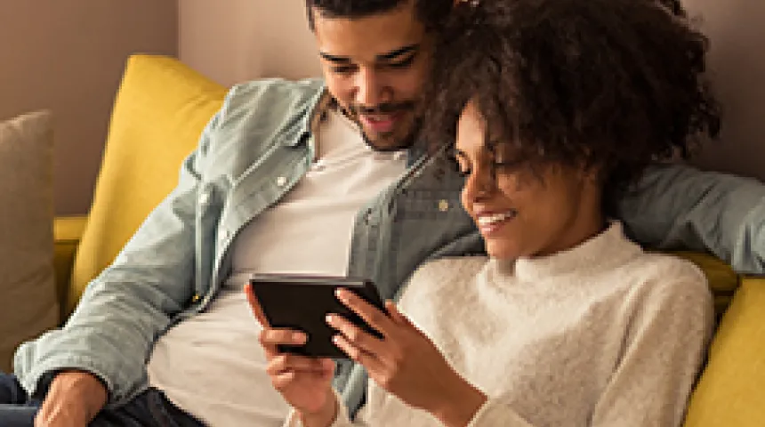 Two people looking at a phone.