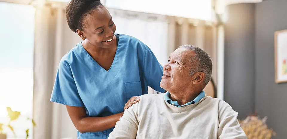 Image of a caregiver smiling down at a patient