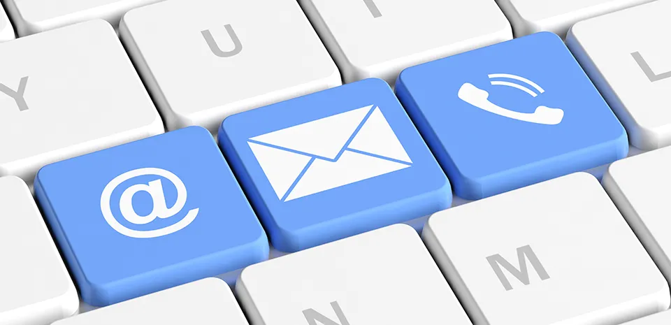 A closeup of three keys on a keyboard used to direct messages: an envelope, a phone, the @ key