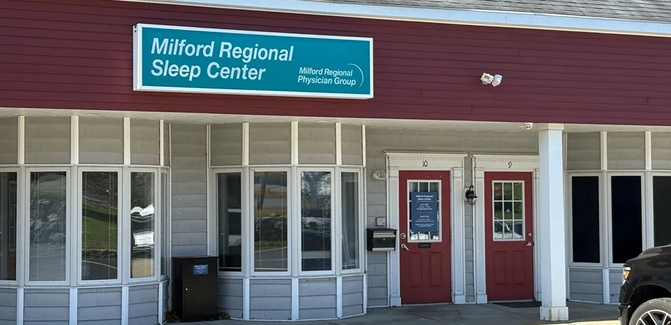 The exterior of Milford Regional Sleep Center in Milford, Mass. The white building has a red facade.