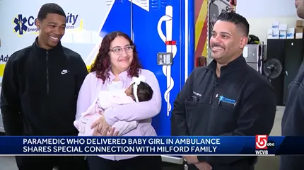 The Alvarez family smiles as the paramedic who delivered Mariah speaks with the reporter.