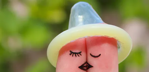 condom on top of fingers to look like hat