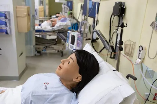 A human mannequin is shown in the HealthAlliance-Clinton simulation room, where students receive support and education from trainers.