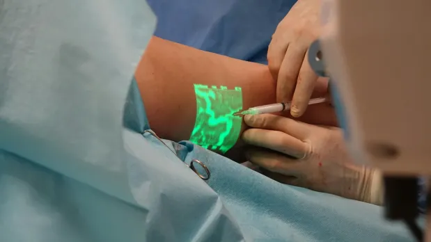 Close-up photo of provider using AI tool to treat a patient