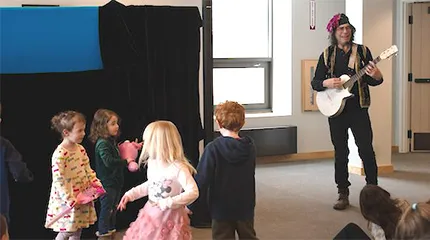 A character from Caravan Puppets performs at the Sherborn Library where donations were collected for long-term UMass Memorial Health patients.