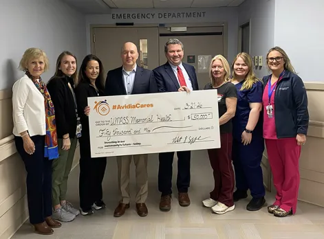 Rob Cozzone, President and CEO of Avidia Bank, presents a large-sized check for $50,000.00 to support the expansion of the Emergency Department at the Marlborough Campus.