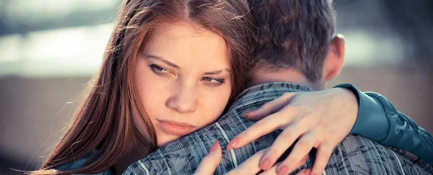 teens in a relationship hugging