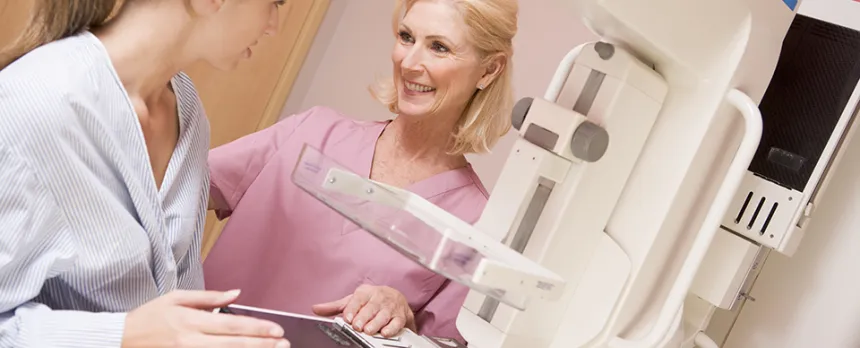 nurse prepping woman for mammogram