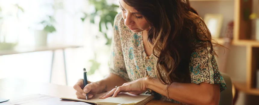 woman writing in her journal